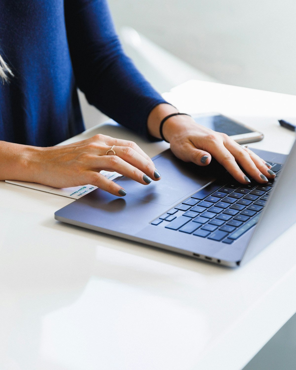 Marketing team member working on a laptop at a desk