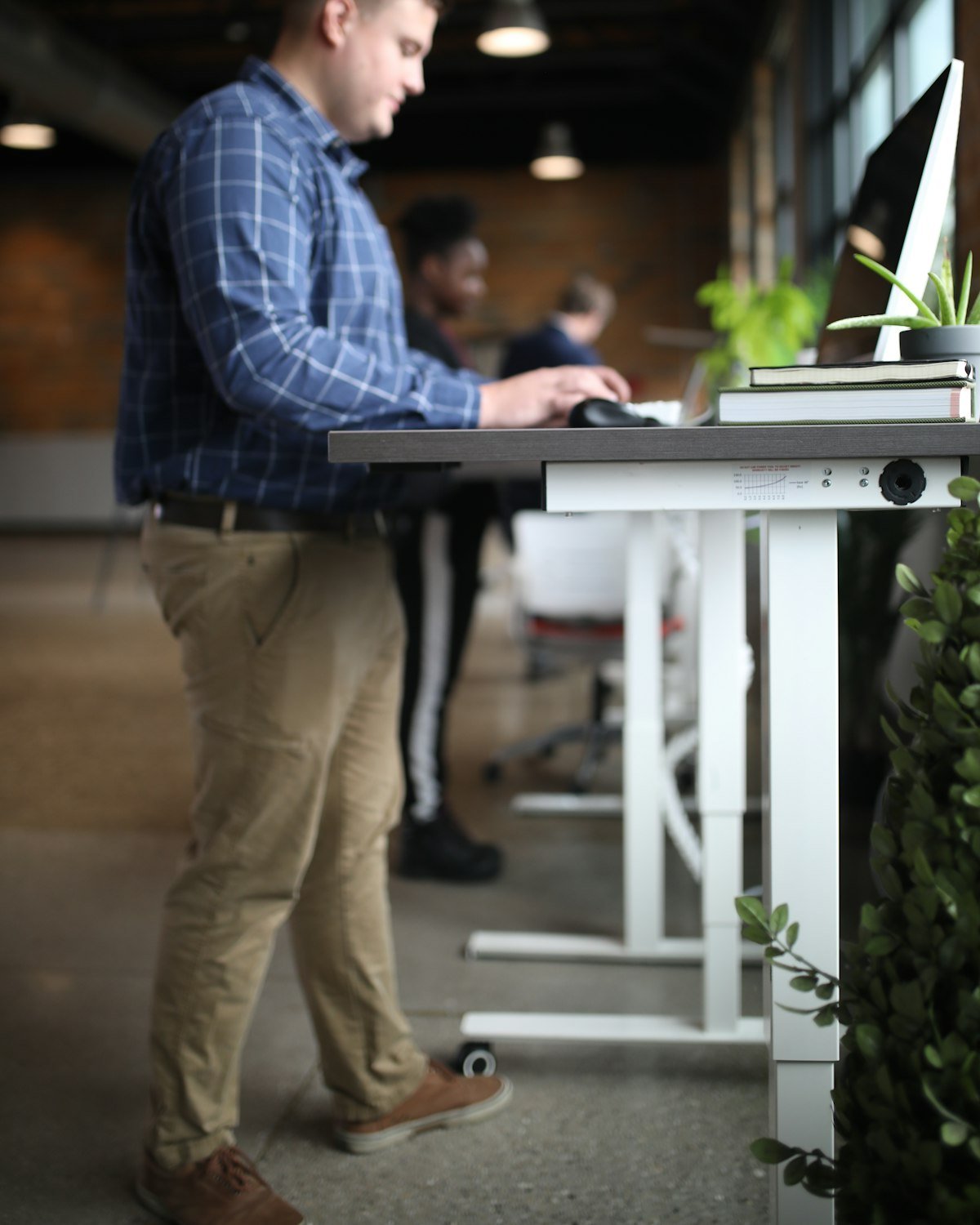 Marketing team member working at a standing desk in a modern office