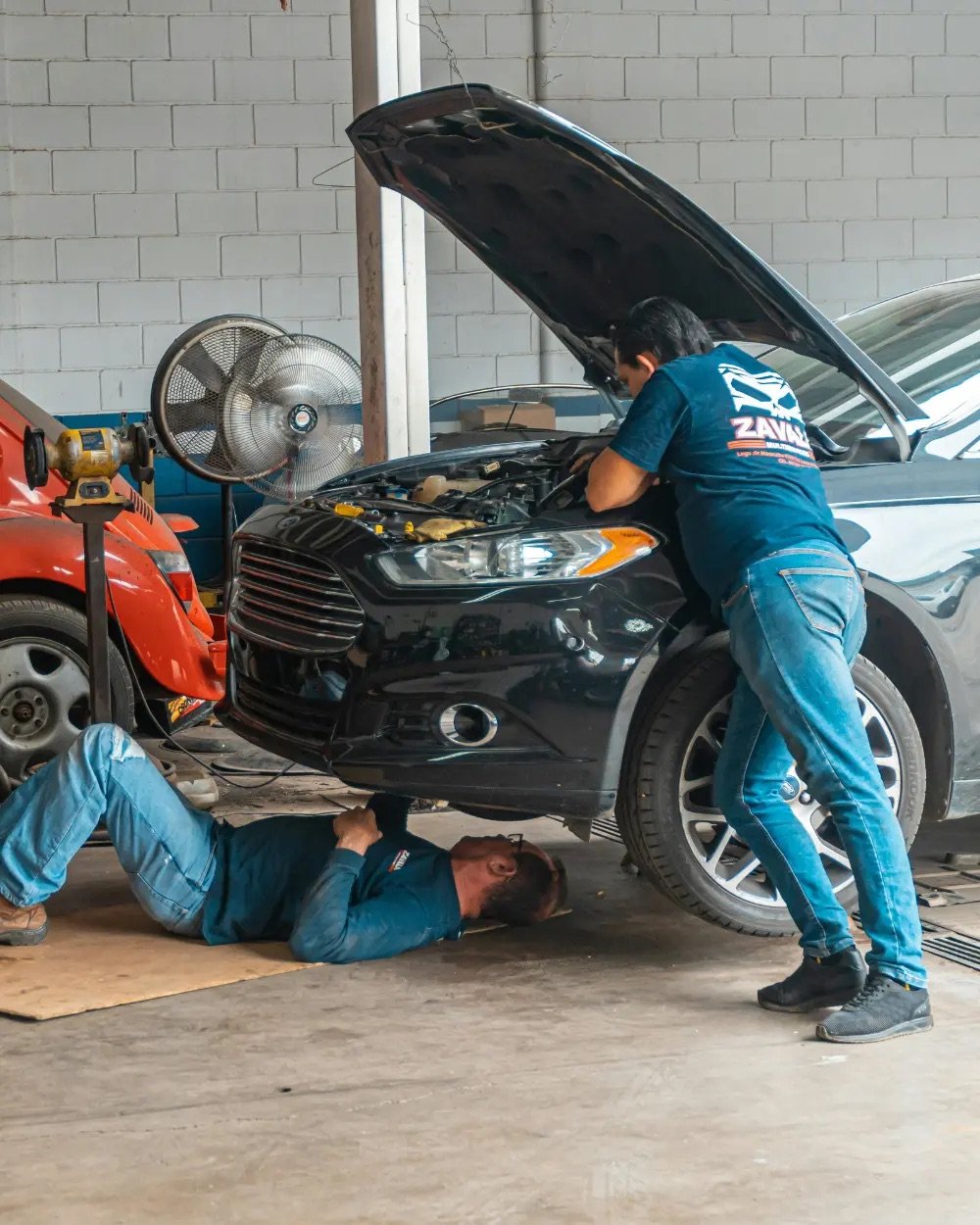 Auto technician repairing a vehicle in a repair shop