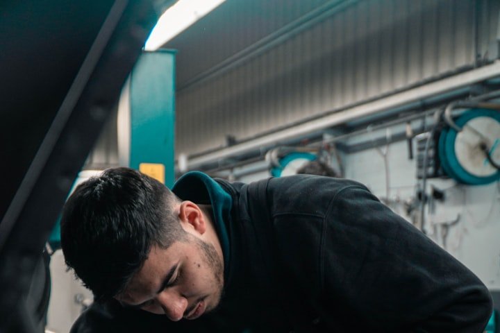 Mechanic repairing a car in a shop