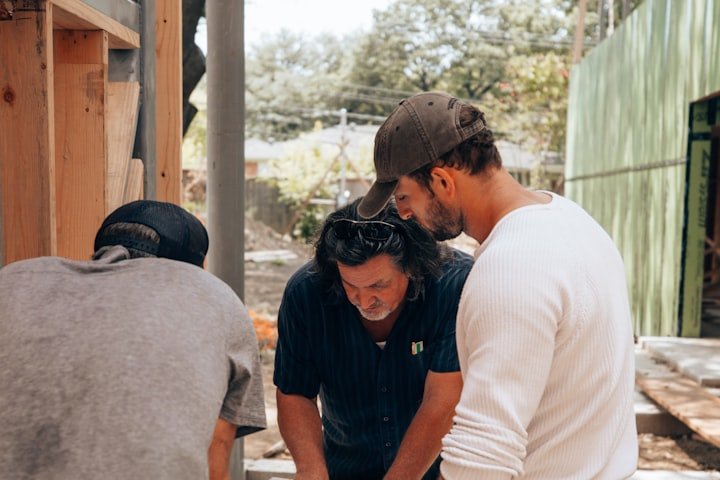 Contractor reviewing blueprints on site