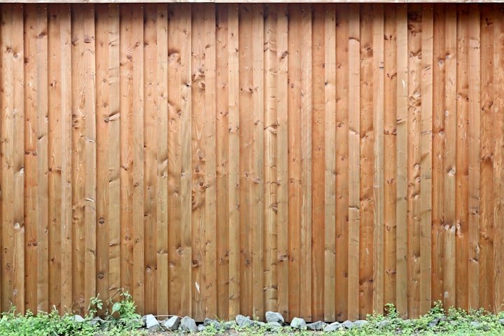 Worker building a wood fence