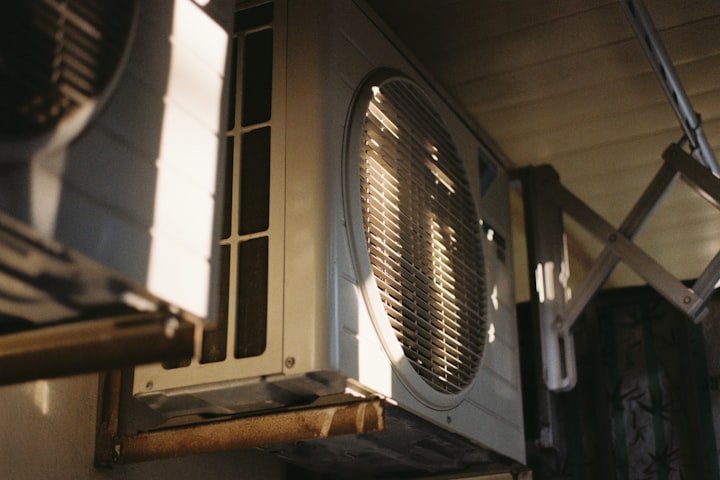 HVAC technician servicing an outdoor AC unit